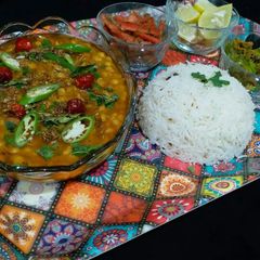 A picture of Chana daal serve with zeera rice and besan wali mirch.
