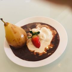 A picture of Exotic Poached Pear in Chocolate Sauce.