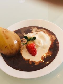 A picture of Exotic Poached Pear in Chocolate Sauce.