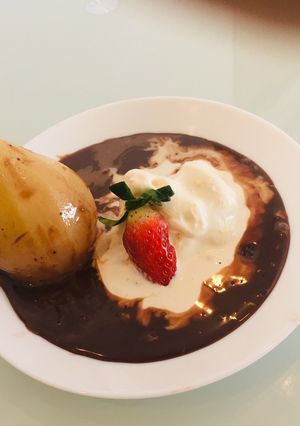 A picture of Exotic Poached Pear in Chocolate Sauce.