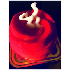 A picture of Red Velvet Cheesecake Mousse with white chocolate frosting.