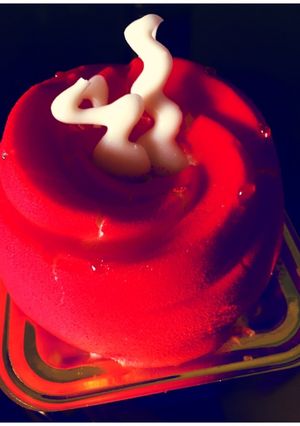 A picture of Red Velvet Cheesecake Mousse with white chocolate frosting.