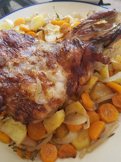 A picture of Leg of lamb roasted slowly in white wine and fresh herbs.