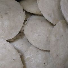 A picture of Idli with sambhar and greenchutney.