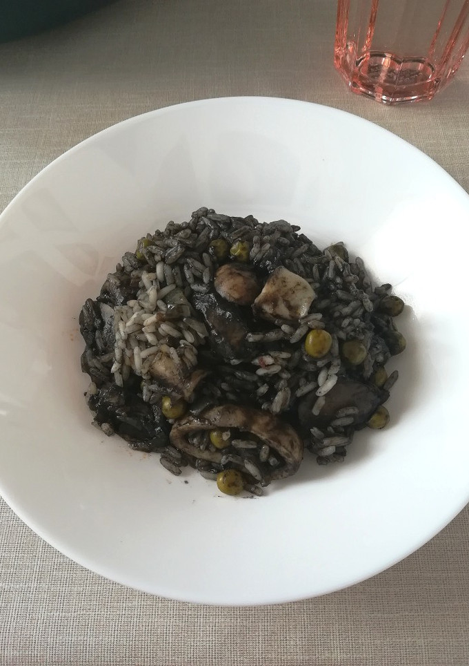 Una foto de Arroz negro con pescado y champiñones