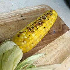 A picture of Miso Butter Corn with Togarashi and Furikake.