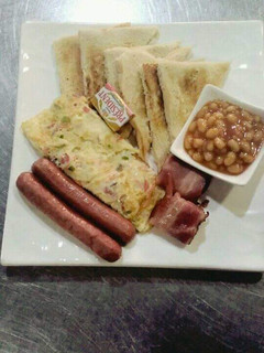 A picture of Sausages,omellete,bread and beans.