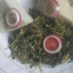 A picture of Ugali and mixed vegetables.