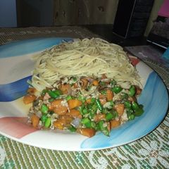 A picture of Spaghetti and veggie sauce with eggs.