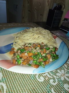 A picture of Spaghetti and veggie sauce with eggs.