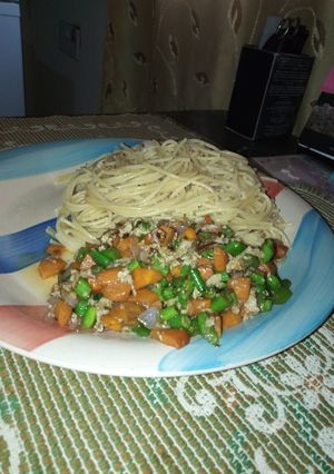 A picture of Spaghetti and veggie sauce with eggs.