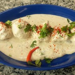 A picture of Moong daal balls in spicy curd.