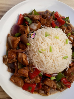 A picture of Chicken in Black Pepper Sauce with Steamed Basmati Rice.
