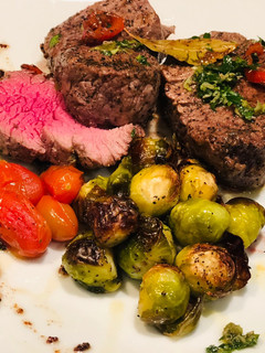 Una foto de Roasted Brussel Sprout, and Rocoto Capers and Bay Leaves Beef Tenderloin - Lomo en Laurel y Coles