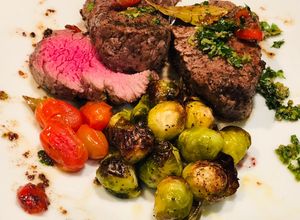 Una foto de Roasted Brussel Sprout, and Rocoto Capers and Bay Leaves Beef Tenderloin - Lomo en Laurel y Coles