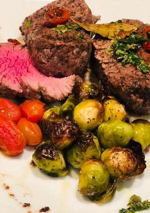 Una foto de Roasted Brussel Sprout, and Rocoto Capers and Bay Leaves Beef Tenderloin - Lomo en Laurel y Coles