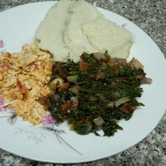 Ugali, scrambled eggs & greens A picture of Ugali, scrambled eggs & greens.