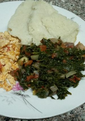 A picture of Ugali, scrambled eggs & greens.