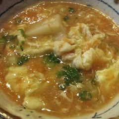 A picture of Carrot Egg Drop Soup with Mochi Rice Cake.