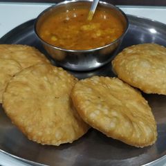 A picture of Kachori with Aloo Sabzi.