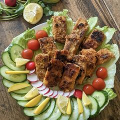 A picture of Fish Fingers with cut salad.