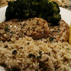 A picture of Grilled Center-cut Pork Chops with Steamed Broccoli and Rice.