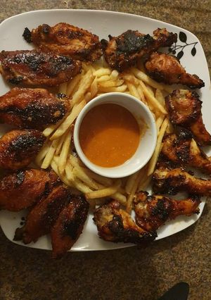 A picture of Crispy hot wings with peri peri sauce.