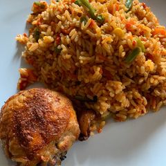 A picture of Nigerian Jollof Rice and Grilled Chicken.