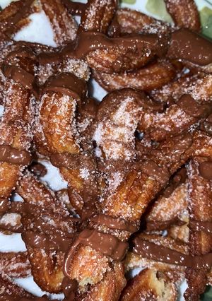 A picture of Churros with Sugar and Nutella.