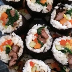 A picture of rolled rice with beef.