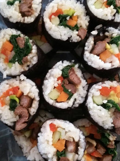 A picture of rolled rice with beef.