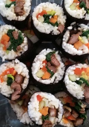 A picture of rolled rice with beef.