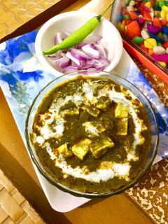 A picture of Palak paneer(Palak paneer in red gravy).