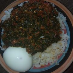 A picture of White rice with veggies sauces.