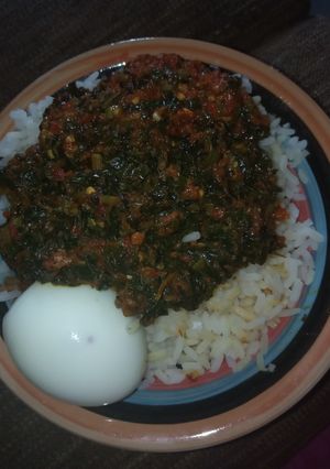A picture of White rice with veggies sauces.