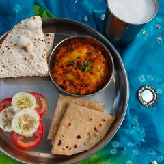 Gujarati Style Bharva Parwal with Besan accompanied with Phulkas A picture of Gujarati Style Bharva Parwal with Besan accompanied with Phulkas.