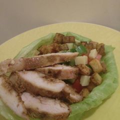 A picture of Honey, ginger chicken and Kiwi infused salad lettuce bowl.