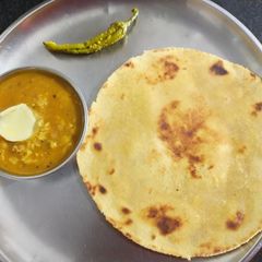 A picture of Dal fry and makki roti.