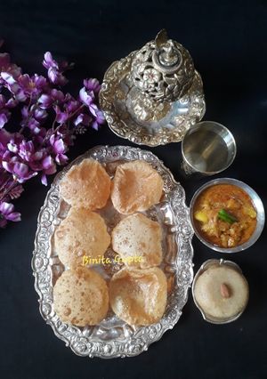 A picture of Puri, Aloo Posto, and Halwa.