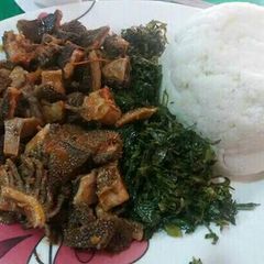 A picture of Ugali served with matumbo and kales.