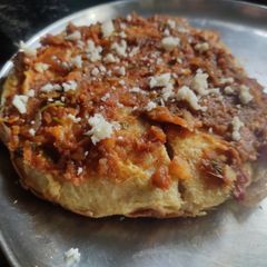 A picture of Egg pav bhaji pizza dosa.