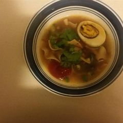 A picture of Chicken noodle soup with mushrooms and some extras.