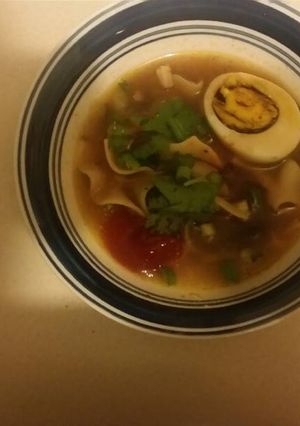 A picture of Chicken noodle soup with mushrooms and some extras.