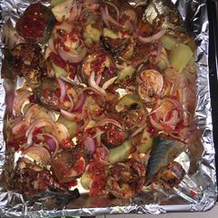 A picture of Roasted fish with potatoes.