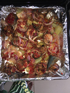 A picture of Roasted fish with potatoes.