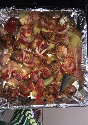 A picture of Roasted fish with potatoes.