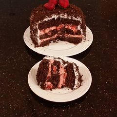 A picture of Chocolate Layer Cake with Strawberry Cream Filling, White Chocolate Ganache Frosting coated with a Chocolate Crumble.