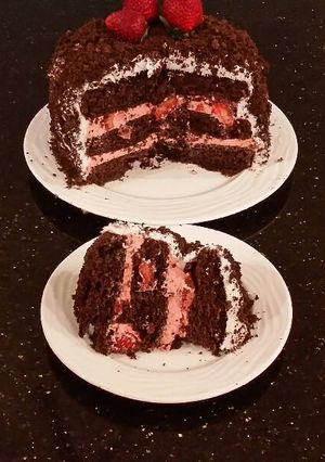 A picture of Chocolate Layer Cake with Strawberry Cream Filling, White Chocolate Ganache Frosting coated with a Chocolate Crumble.