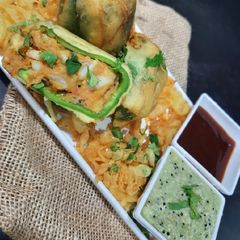 A picture of Stuffed Bell Pepper fritters with ridge gourd (turiya) chutney.