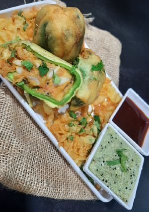 A picture of Stuffed Bell Pepper fritters with ridge gourd (turiya) chutney.